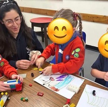 Monique running a craft activity with young people at Scouts